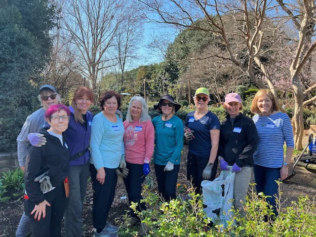 Garden club members planting and maintaining the community garden.